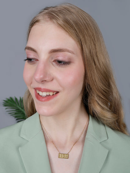 A woman wearing a dainty 11:11 angel number pendant, demonstrating the fit and style of these modern gold necklace designs gold.
