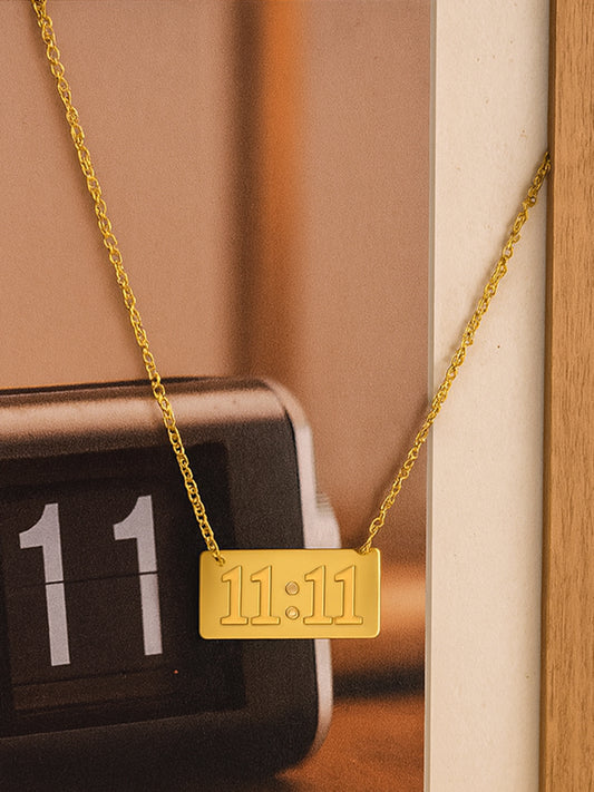 Gold necklace design with engraved 11:11 rectangular pendant on chain