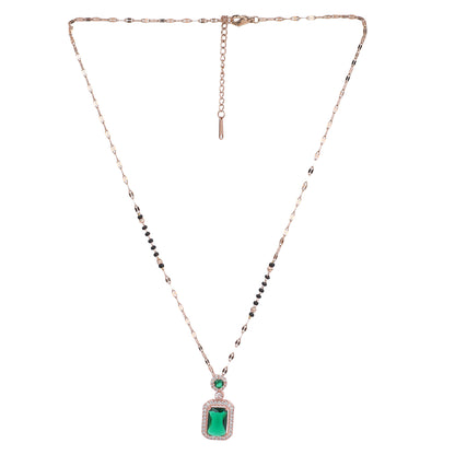 Artificial mangalsutra with gold-toned chain and green stone pendant on a white background