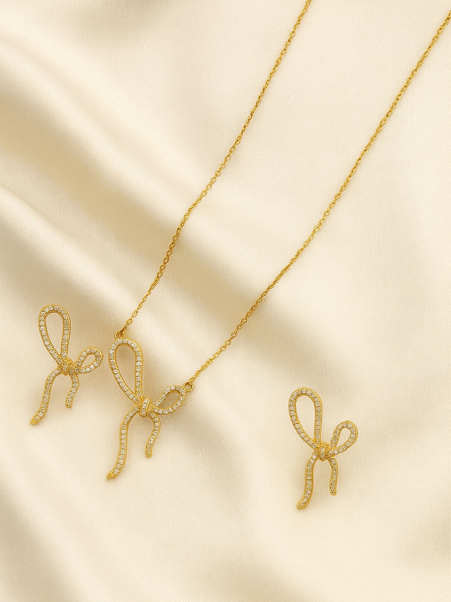 Gold-tone bow-knot necklace and matching earrings set for women, featuring crystal embellishments