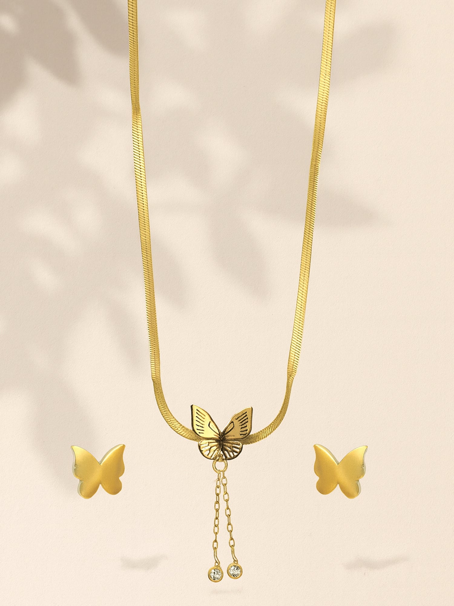 Gold snake chain necklace for women with a butterfly pendant and matching stud earrings