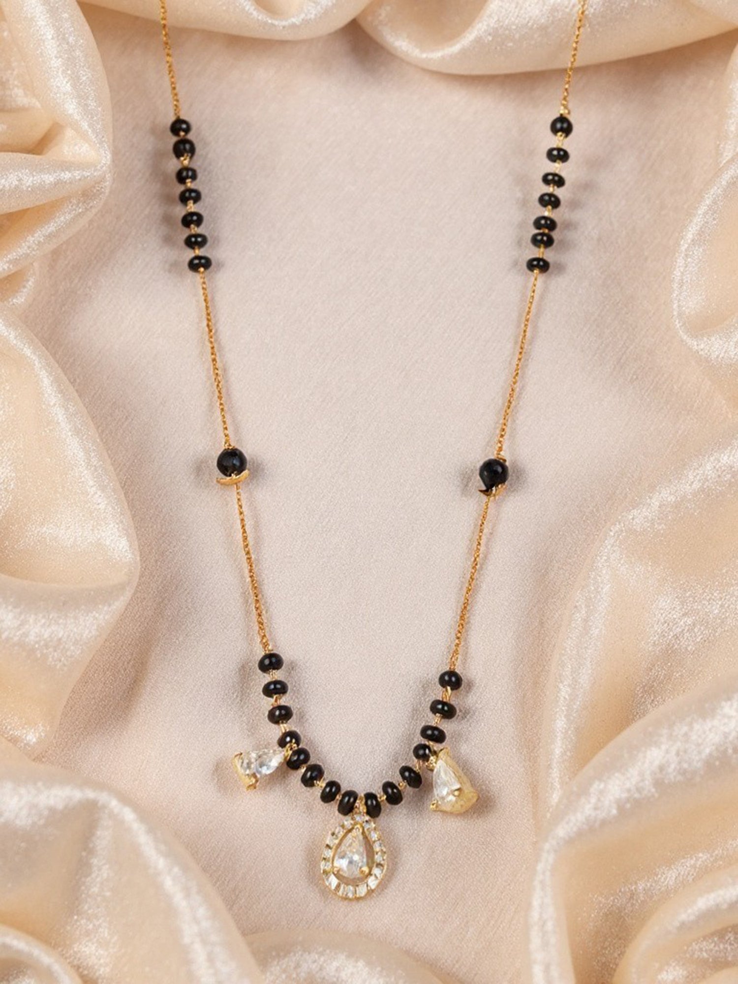 Latest gold-plated mangalsutra design with black beads and a sparkling CZ teardrop pendant on a fine chain