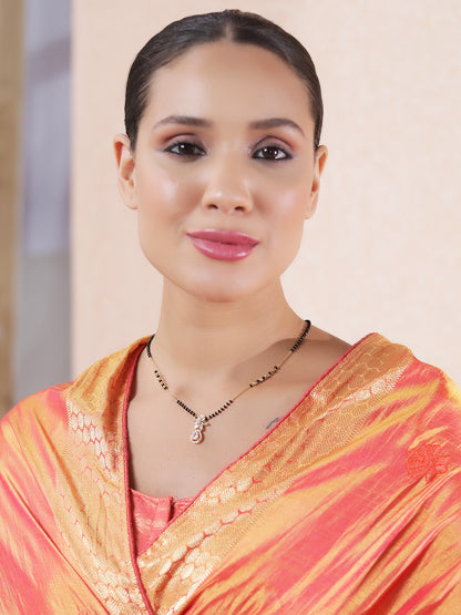 Model wearing a traditional mangalsutra design with black beads and a classic pendant