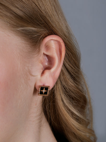 Bold gold necklace for women featuring a square black enamel pendant with a central star design and crystal accents