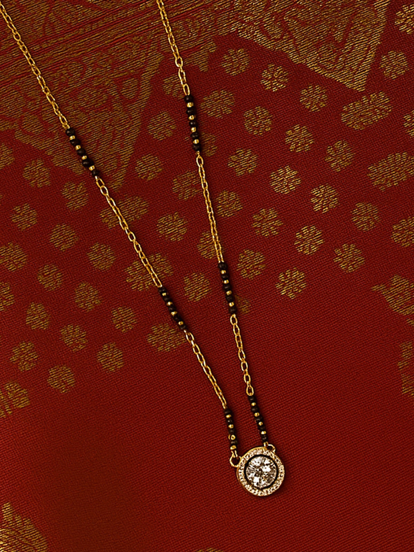 Simple modern mangalsutra design in a short length, with a diamond-look solitaire and minimalist black bead detailing