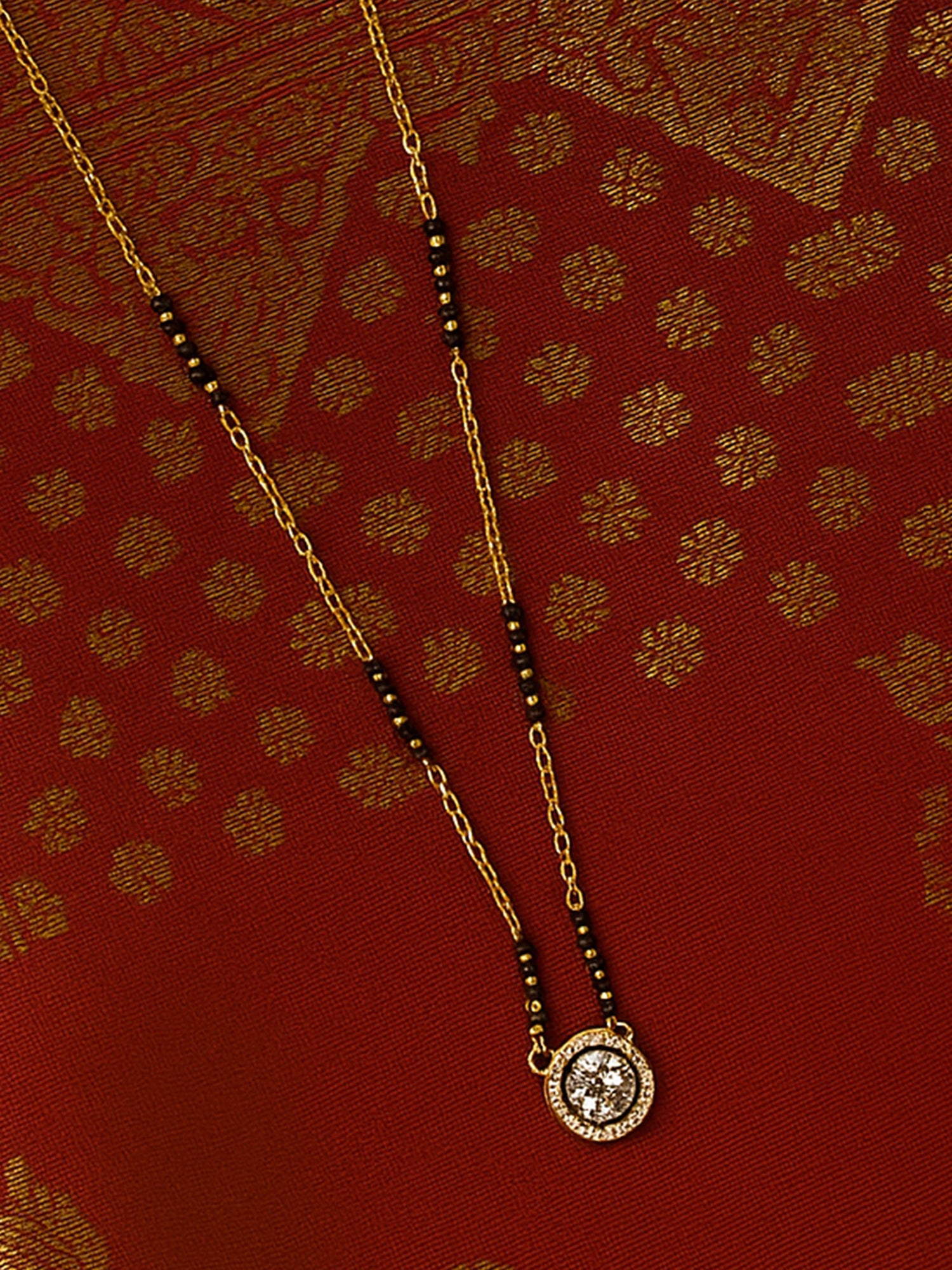 Simple modern mangalsutra design in a short length, with a diamond-look solitaire and minimalist black bead detailing