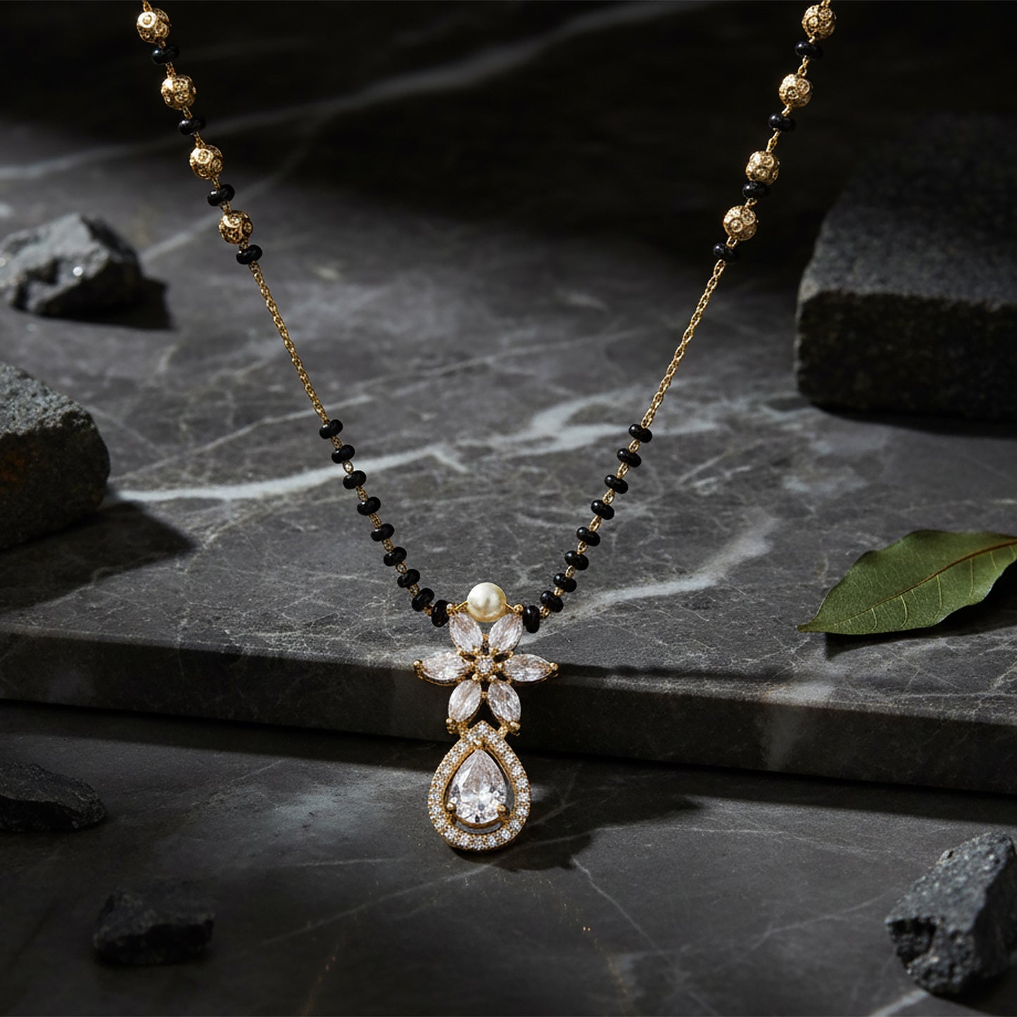 Gold mangalsutra with black beads and crystal floral pendant