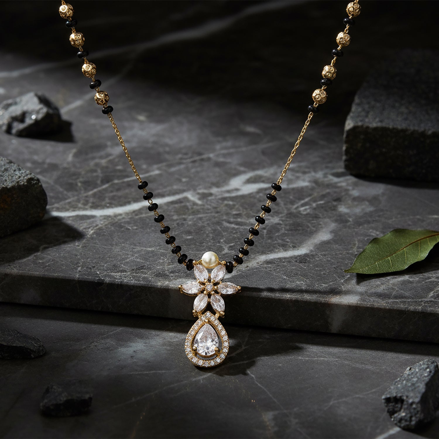 Gold mangalsutra with black beads and crystal floral pendant