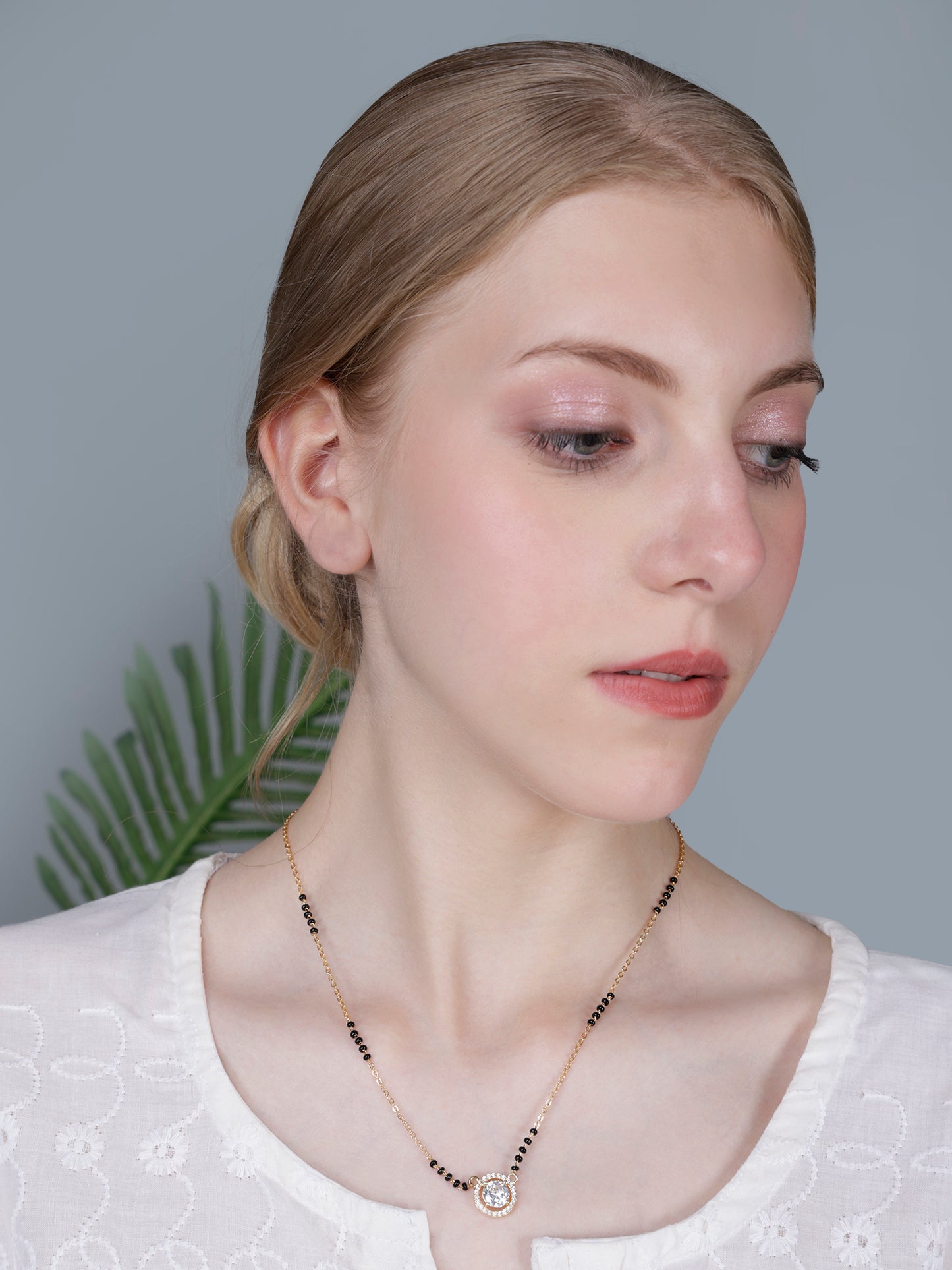 Model wearing a stunning fancy short mangalsutra designs, featuring a dazzling round cubic zirconia solitaire