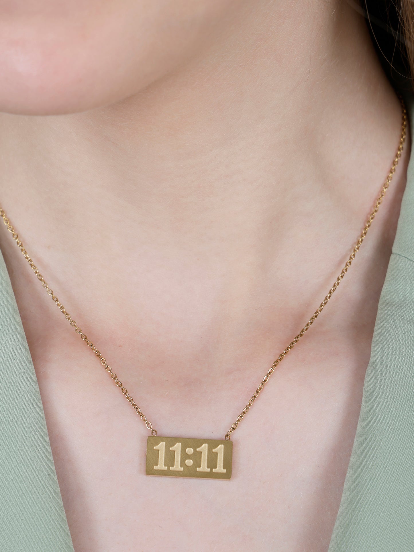 A model wearing a minimalist 11:11 angel number pendant, demonstrating the fit and style of these gold long necklace designs gold.