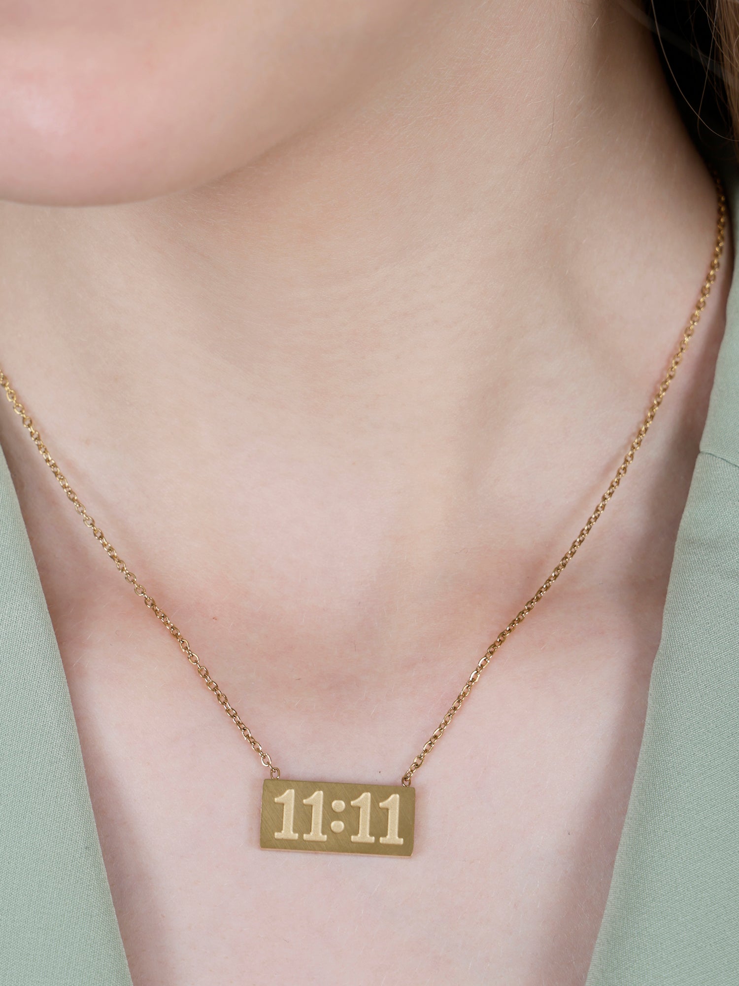A model wearing a minimalist 11:11 angel number pendant, demonstrating the fit and style of these gold long necklace designs gold.