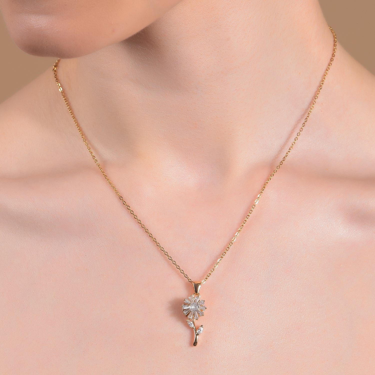 Gold necklace for women featuring a delicate sunflower pendant with clear crystal petals on a thin gold chain