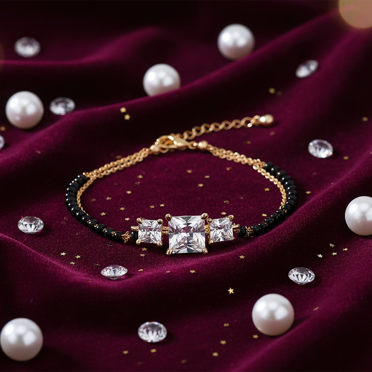 Hand mangalsutra bracelet with black beads and square sparkling stones, displayed on a maroon velvet background with pearls and crystal accents
