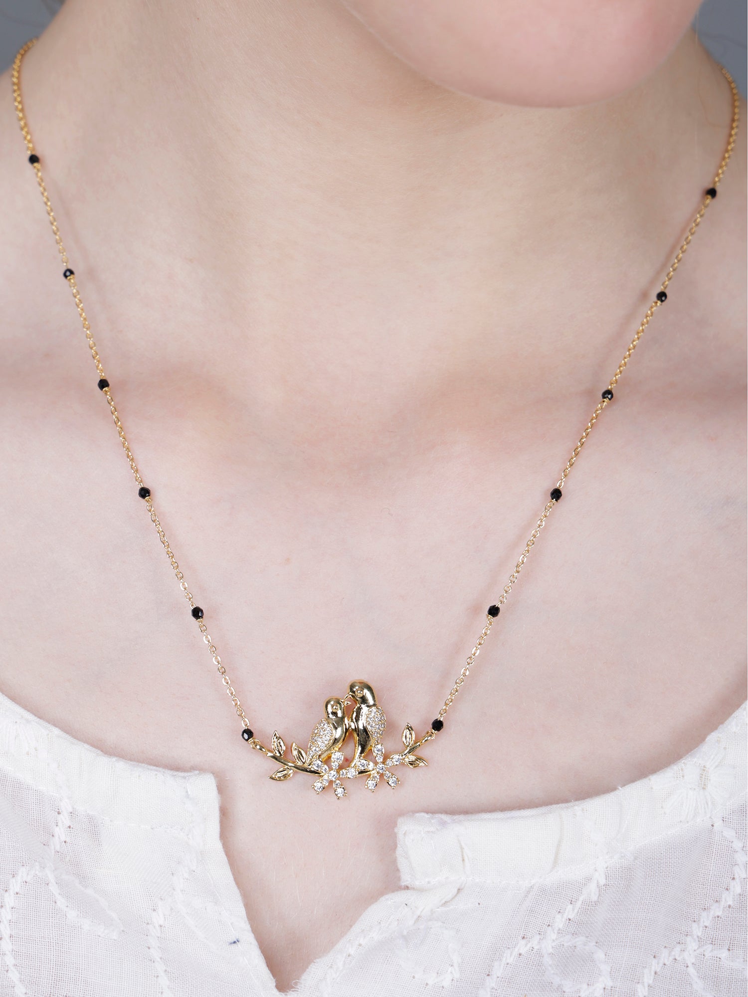Fancy short mangalsutra with gold love birds pendant and black beads