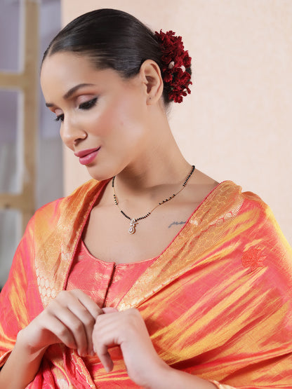 Model wearing the latest gold mangalsutra design with a delicate black-bead chain and elegant pendant