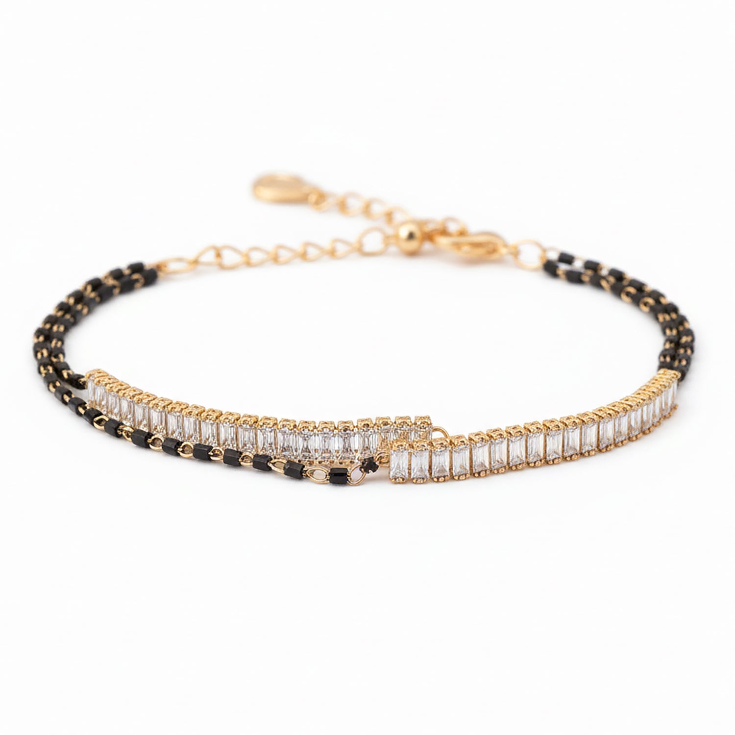 Elegant gold bracelet design for women with black beads and zircon stones.