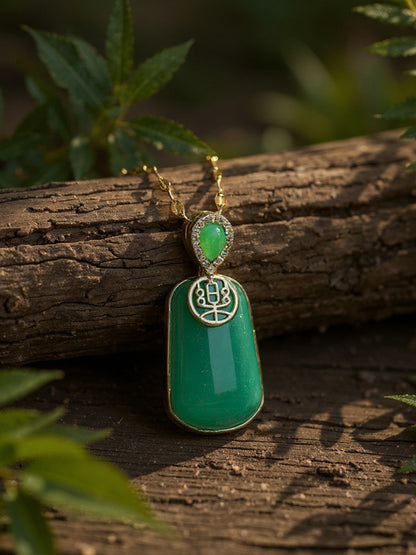 Close-up of an elegant green gemstone gold necklace for women displayed outdoors on wood