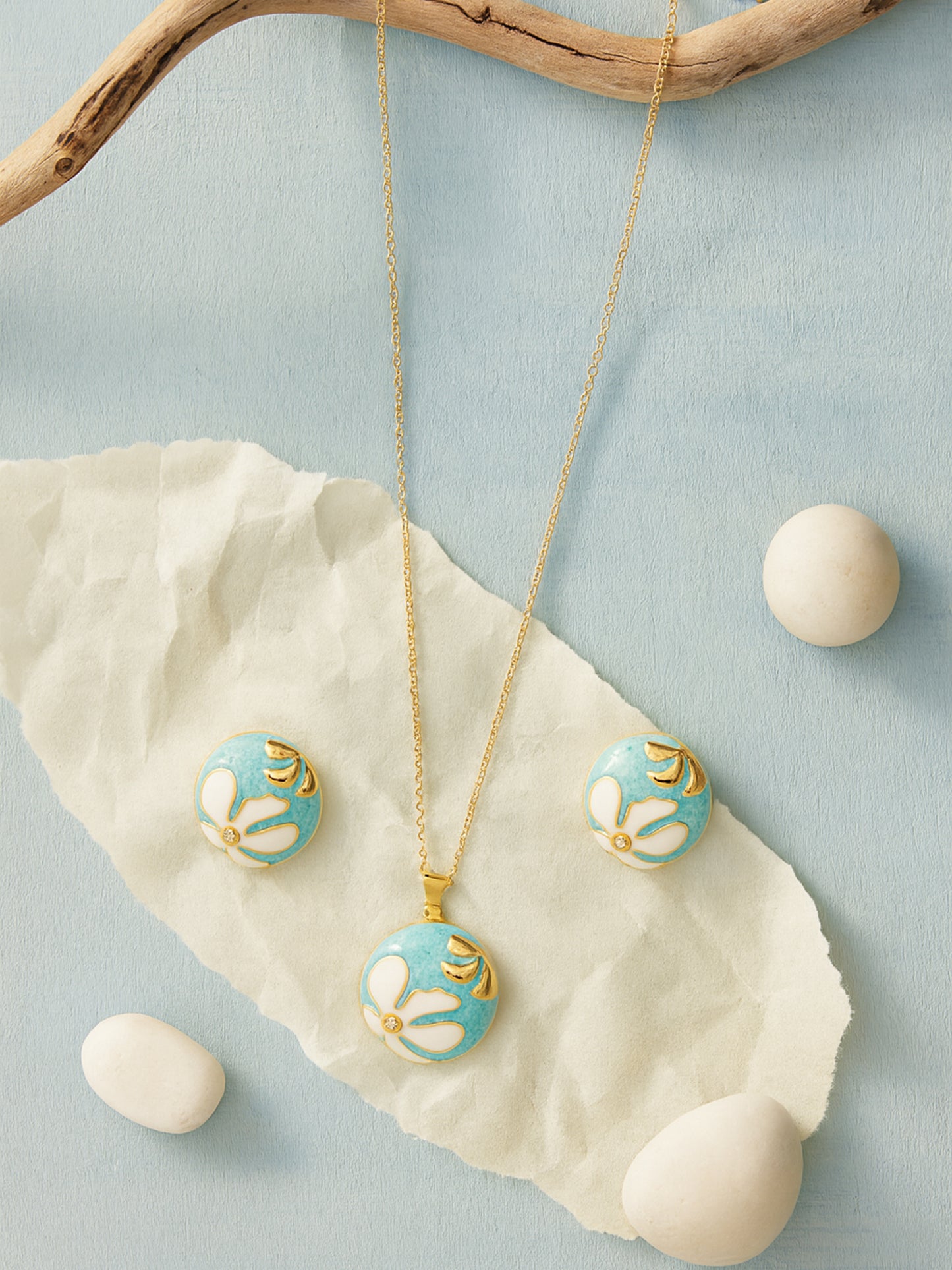 Gold necklace design with a round turquoise and white enamel floral pendant, paired with matching stud earring