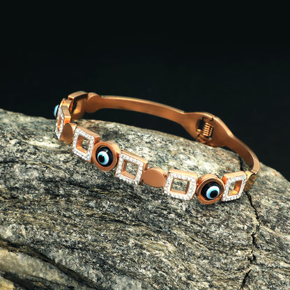 Latest bracelet design featuring rose gold plating, evil eye charms, and geometric crystal squares.