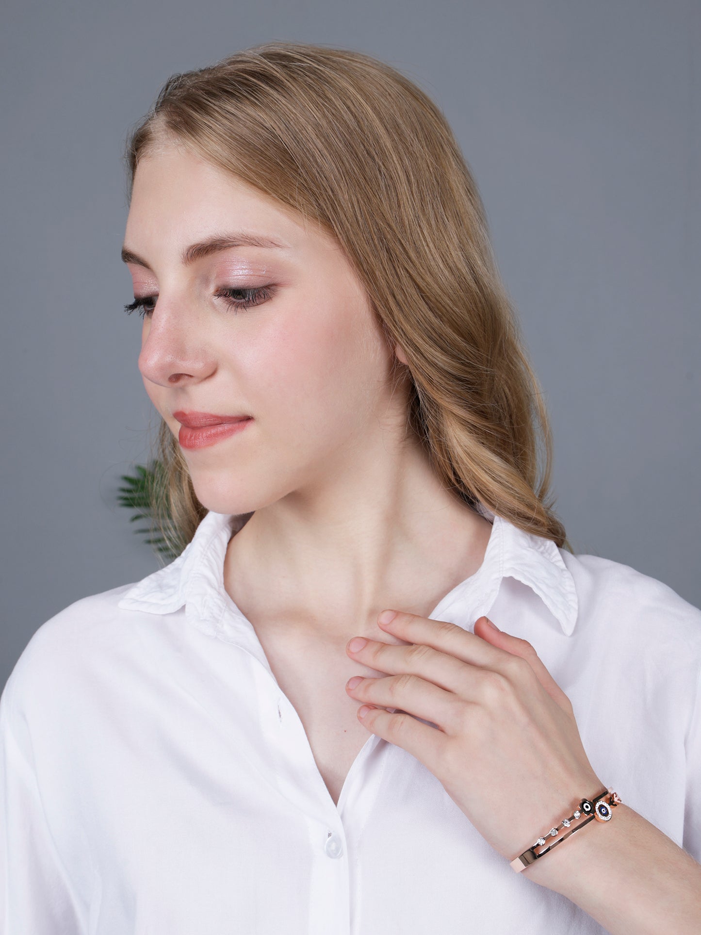 A professional lifestyle shot of a model wearing a hand bracelet for women, perfect for modern office or casual wear.