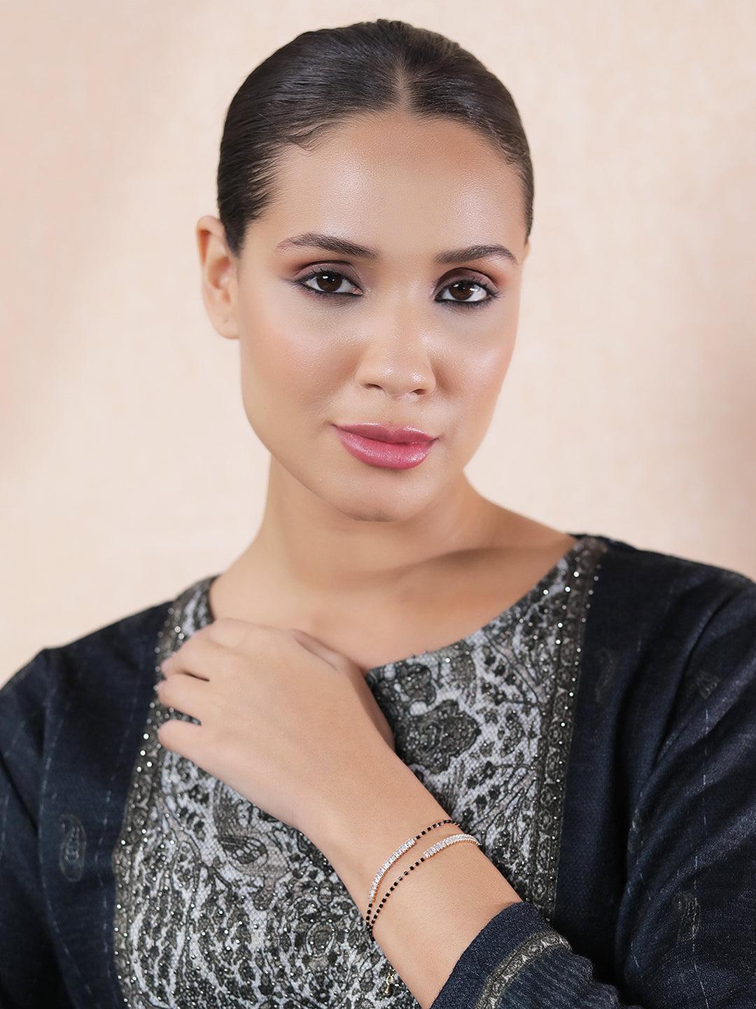 fancy short mangalsutra design worn by a woman in traditional attire