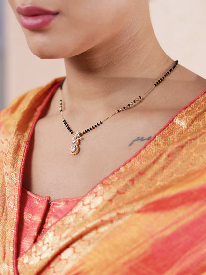 Close-up of the latest mangalsutra design with black beads and a floral gold pendant