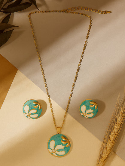 Round gold necklace and earring set featuring a turquoise and white floral enamel design.