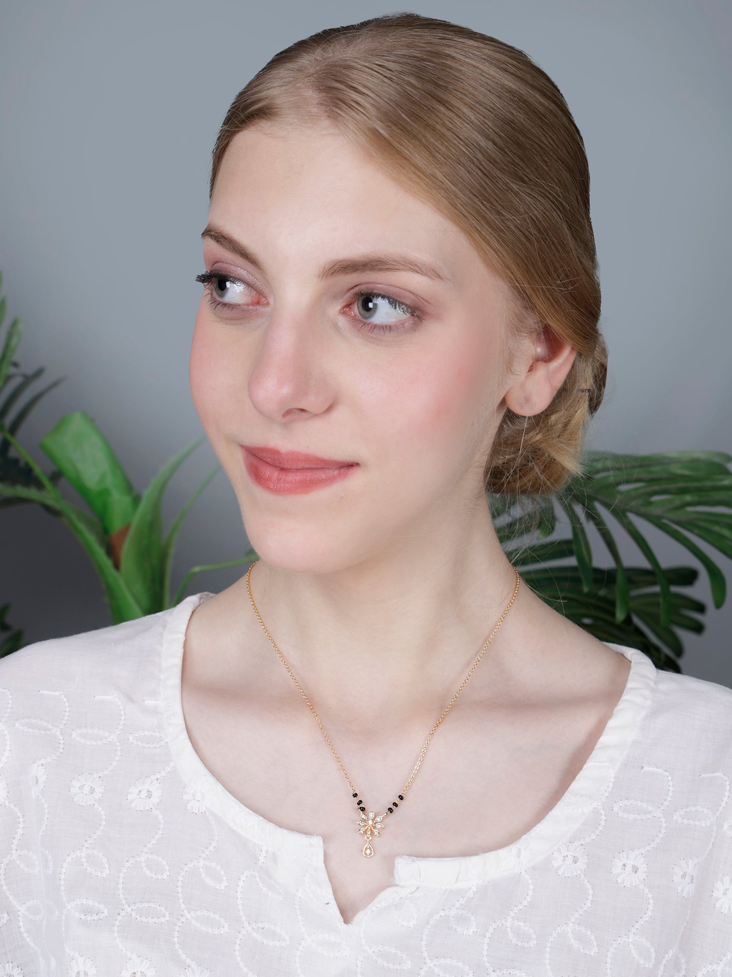 Minimalist simple modern mangalsutra design necklace, perfect for everyday use, with a gold chain and sparkling floral pendant