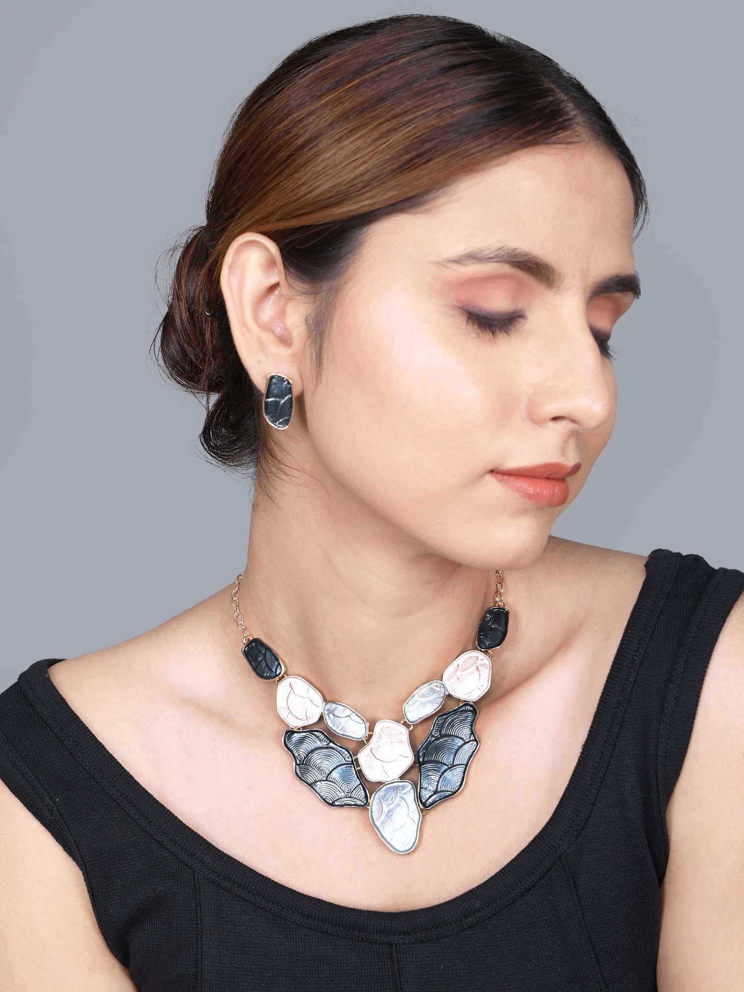 Close-up portrait of a gold necklace for women featuring a bold, colorful pendant design and a classic gold chain.