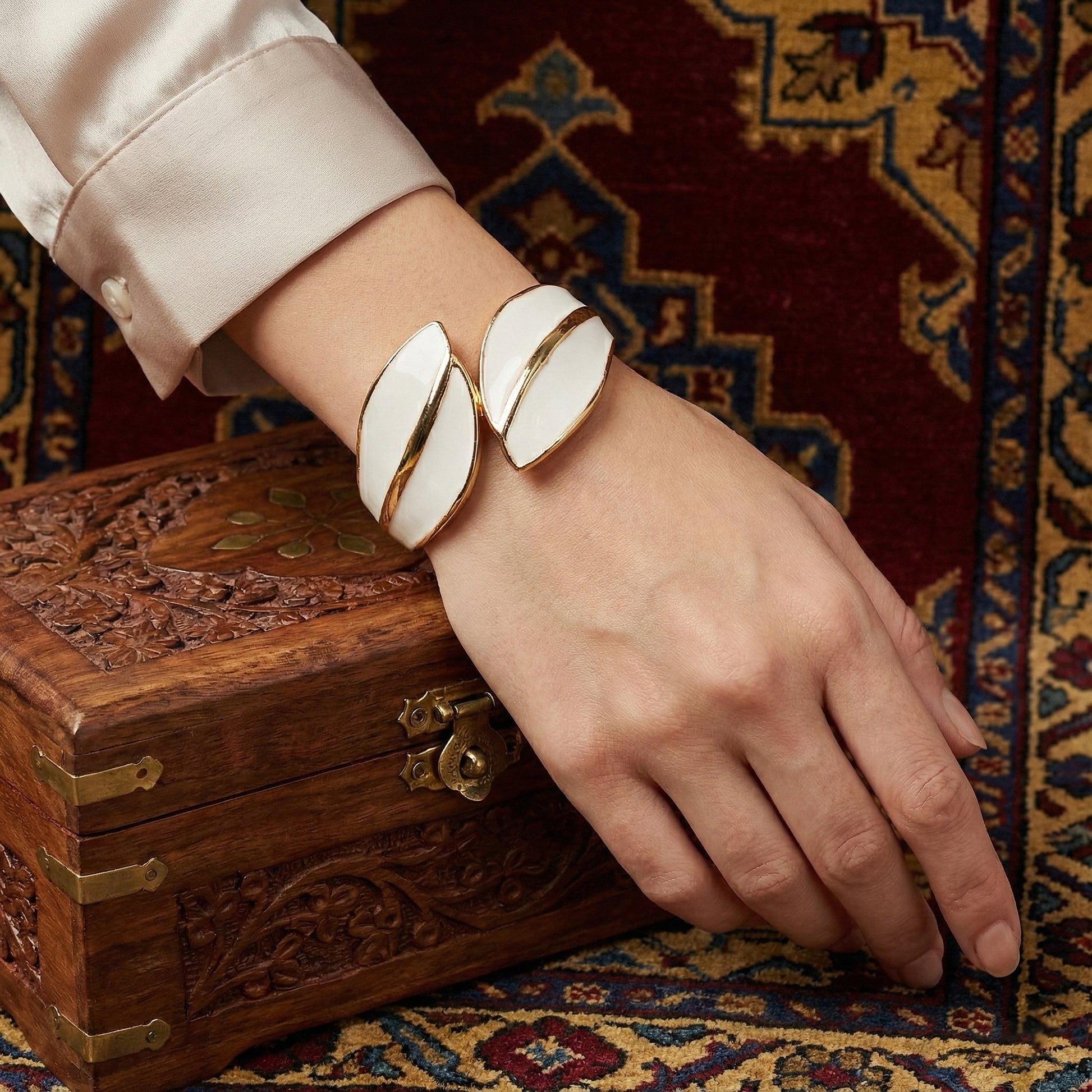 gold plated bracelet for ladies in a leaf-inspired wrap design paired with a silk blouse.