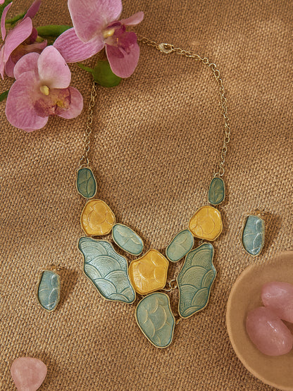 Elegant gold plated silver necklace and earring set paired with pink orchids.