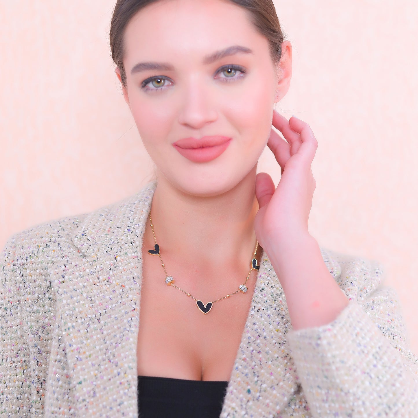 Gold plated silver necklace with heart charms, perfect for layering or wearing as a statement piece.