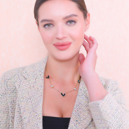 Gold plated silver necklace with heart charms, perfect for layering or wearing as a statement piece.