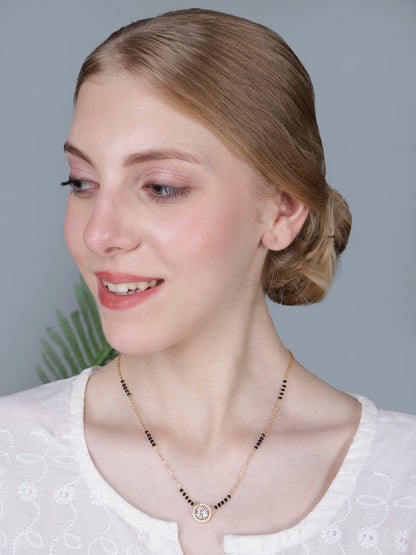 Mangalsutra design gold latest style, displayed with festive red silk fabric and religious accessories