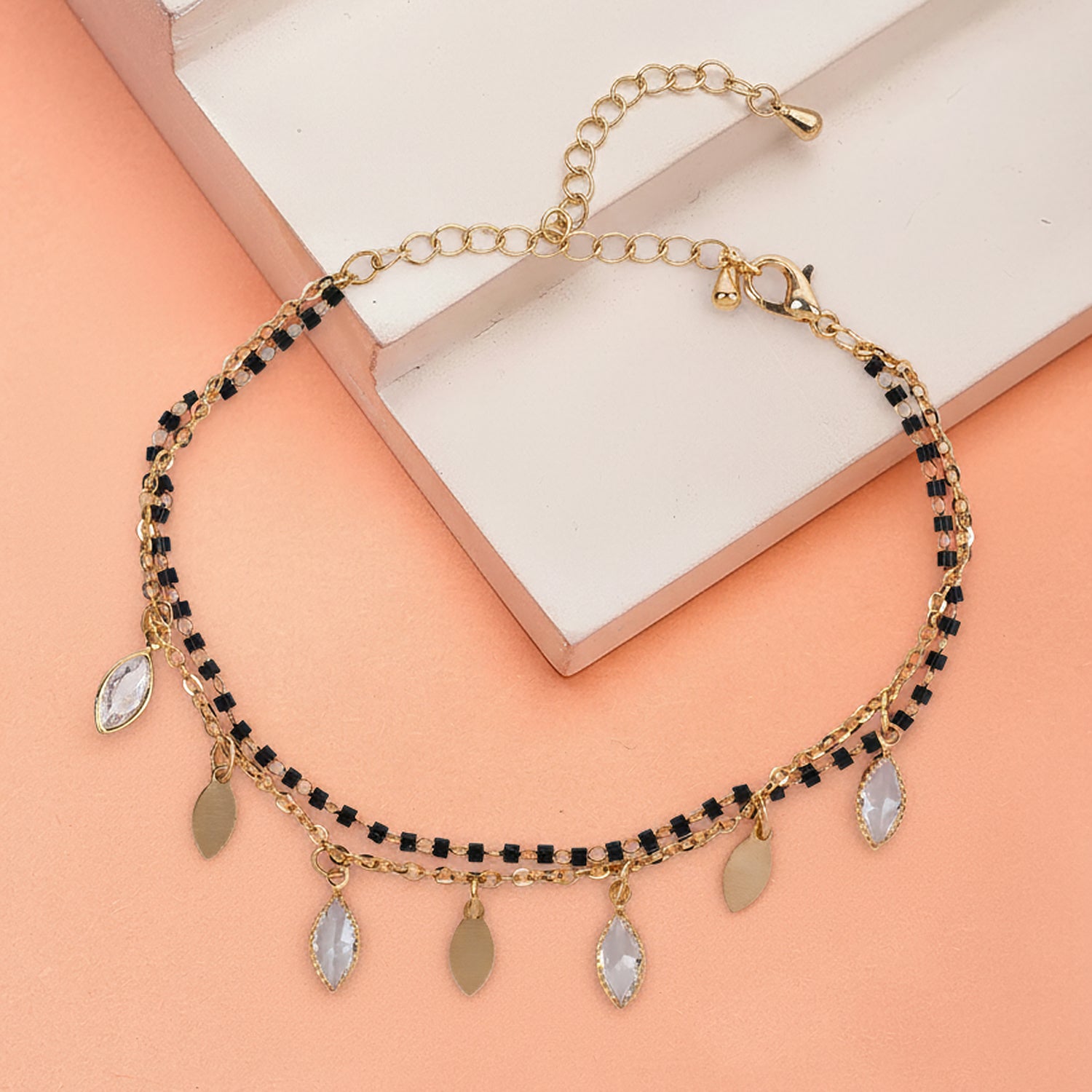 Elegant design of mangalsutra bracelet with black beads and gold charm hangings