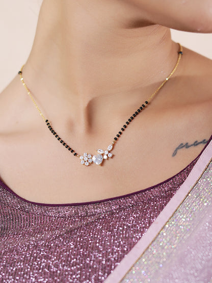 Mangalsutra pendant design in gold with heart and flower on woman