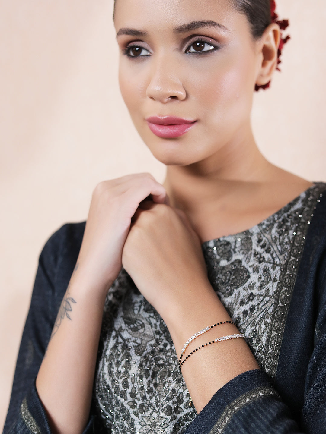 Woman wearing elegant gold jewellery design mangalsutra bracelet set with a traditional outfit