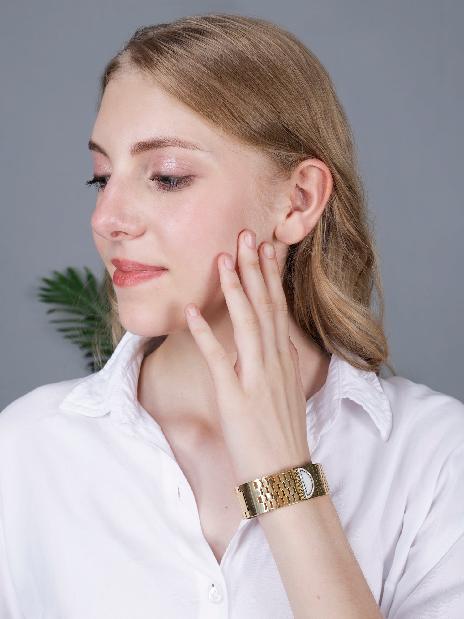 A stylish bracelet for women in a gold-plated finish, shown on a model for a modern look.