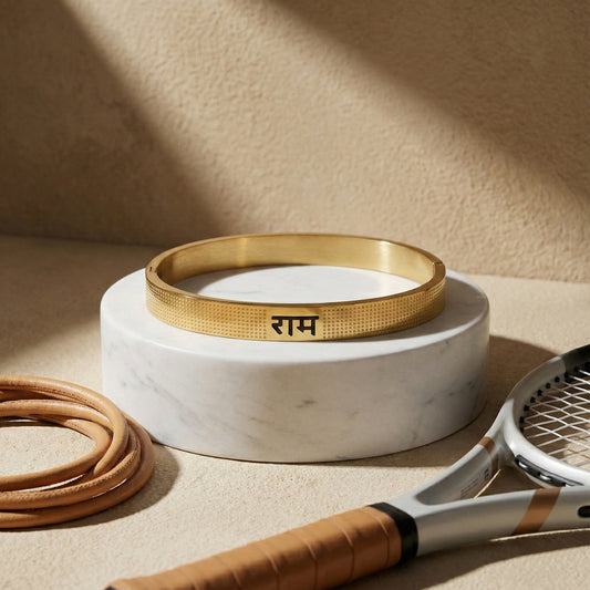 Premium gold bracelet for men displayed on a white marble stand next to a tennis racket.