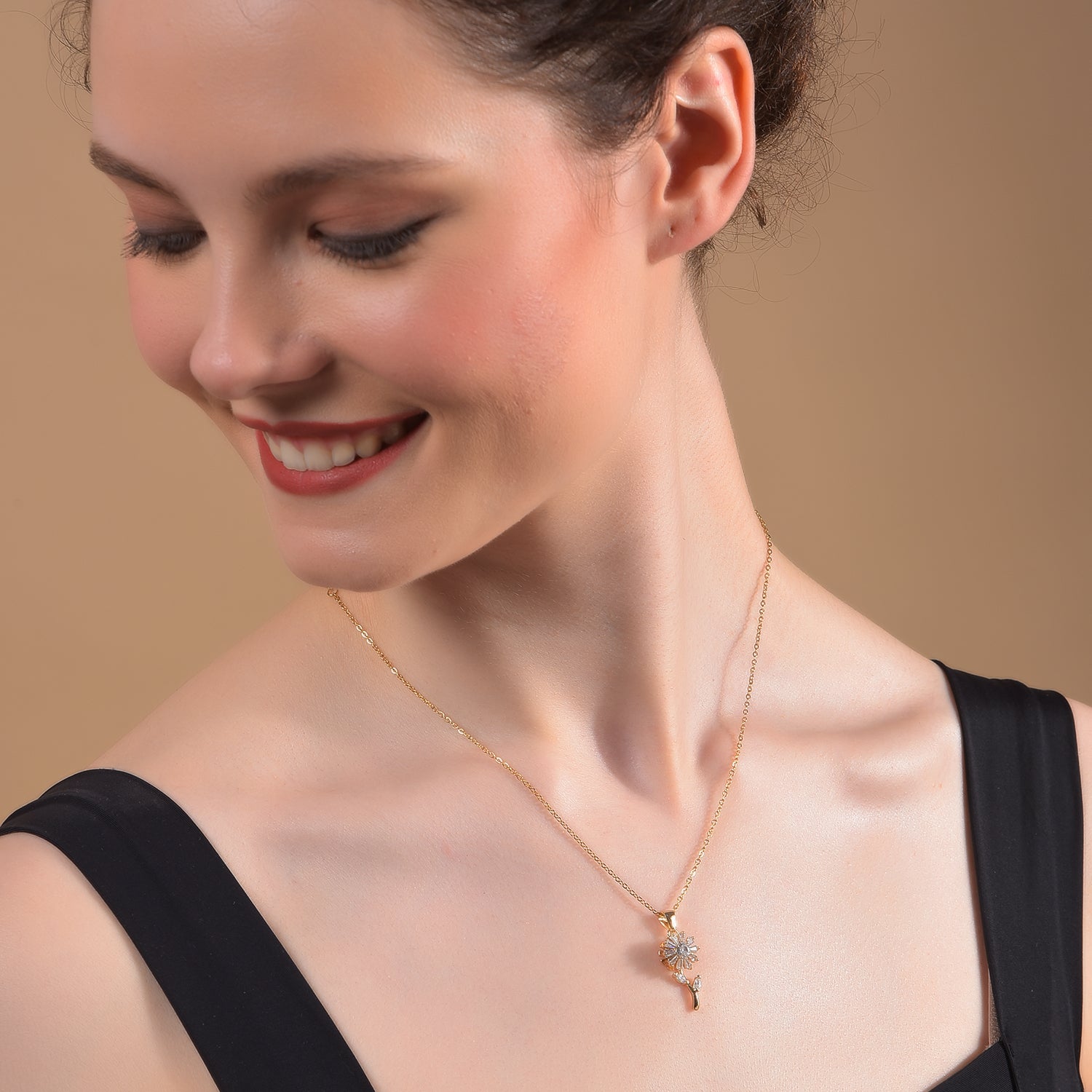 Elegant gold necklace for women featuring a floral diamond-style pendant on a delicate chain.