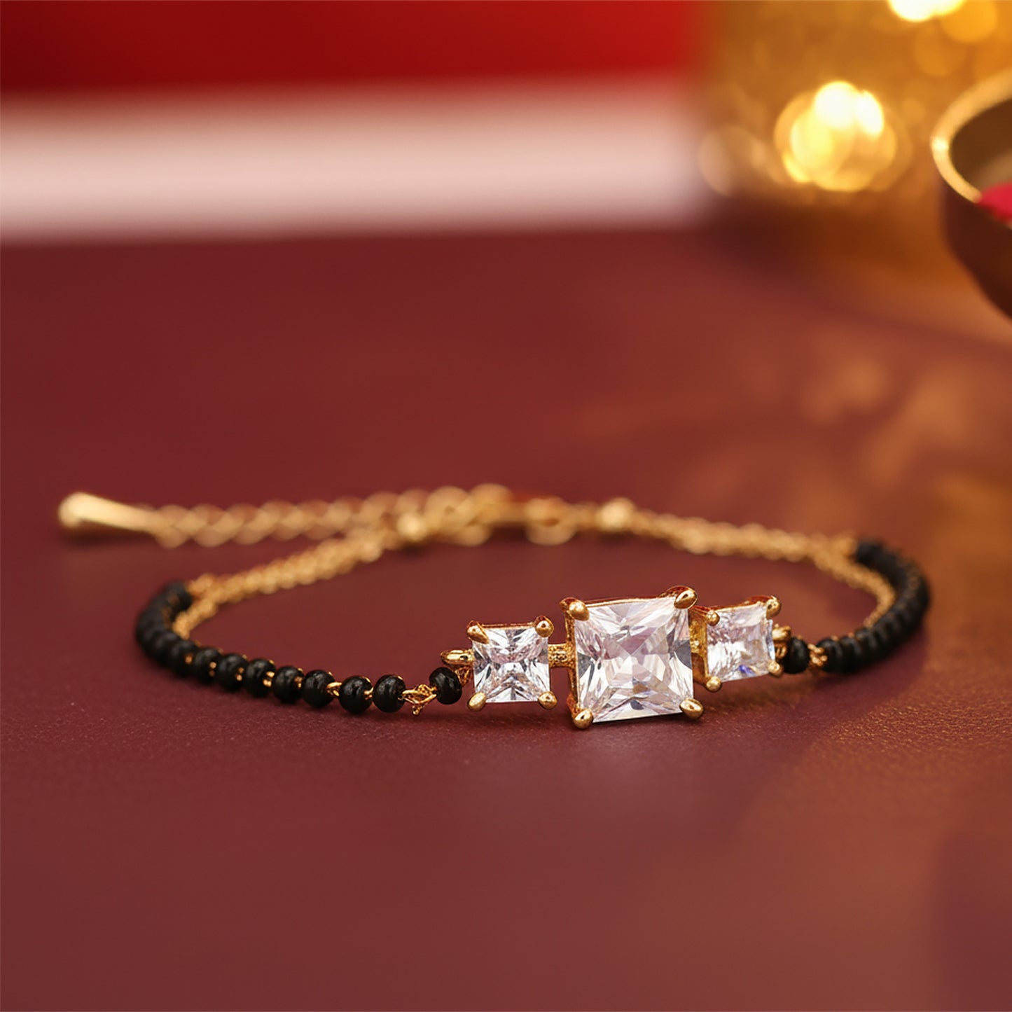 Elegant hand bracelet mangalsutra  with gold chain, black beads, and square-cut stones 