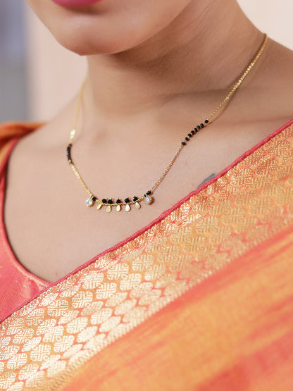 Fancy short mangalsutra design with gold chain, black beads, and small hanging gold charms