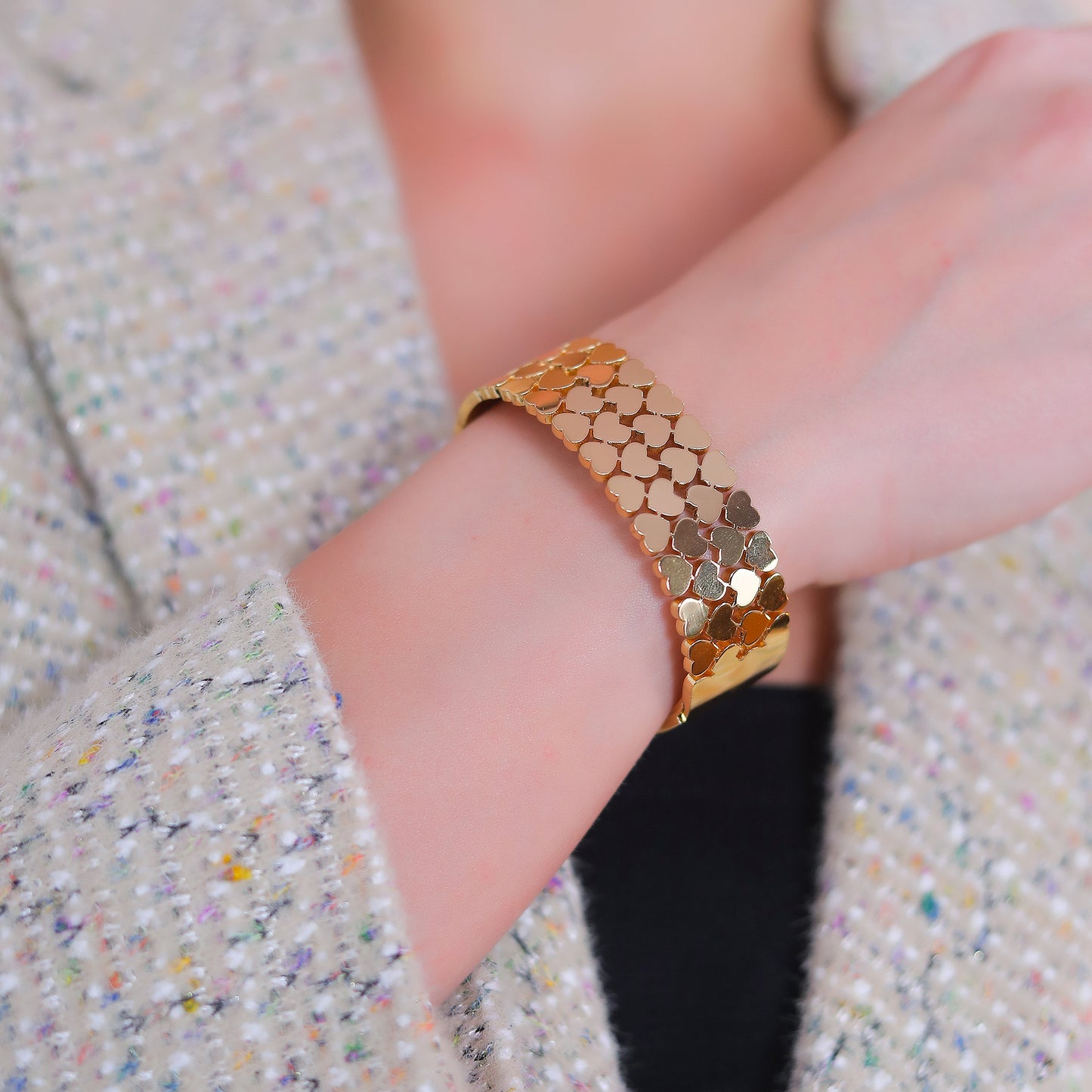 Detailed view of a stylish bracelet for women showcasing the interlocking heart details on a wrist