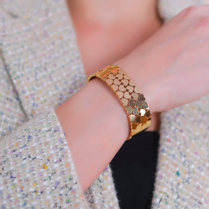 Detailed view of a stylish bracelet for women showcasing the interlocking heart details on a wrist