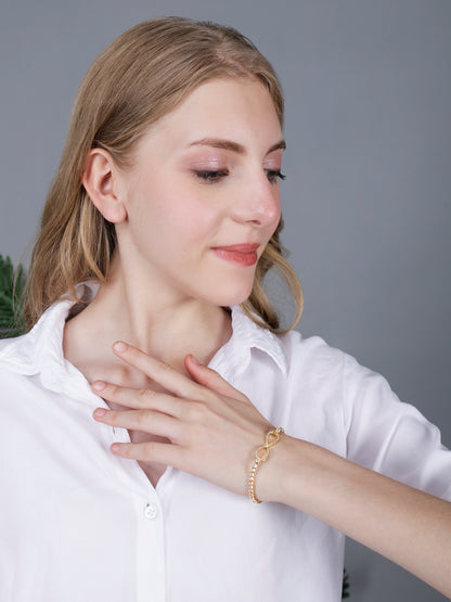 Stylish bracelet for women with infinity charm worn by a model in a white shirt.