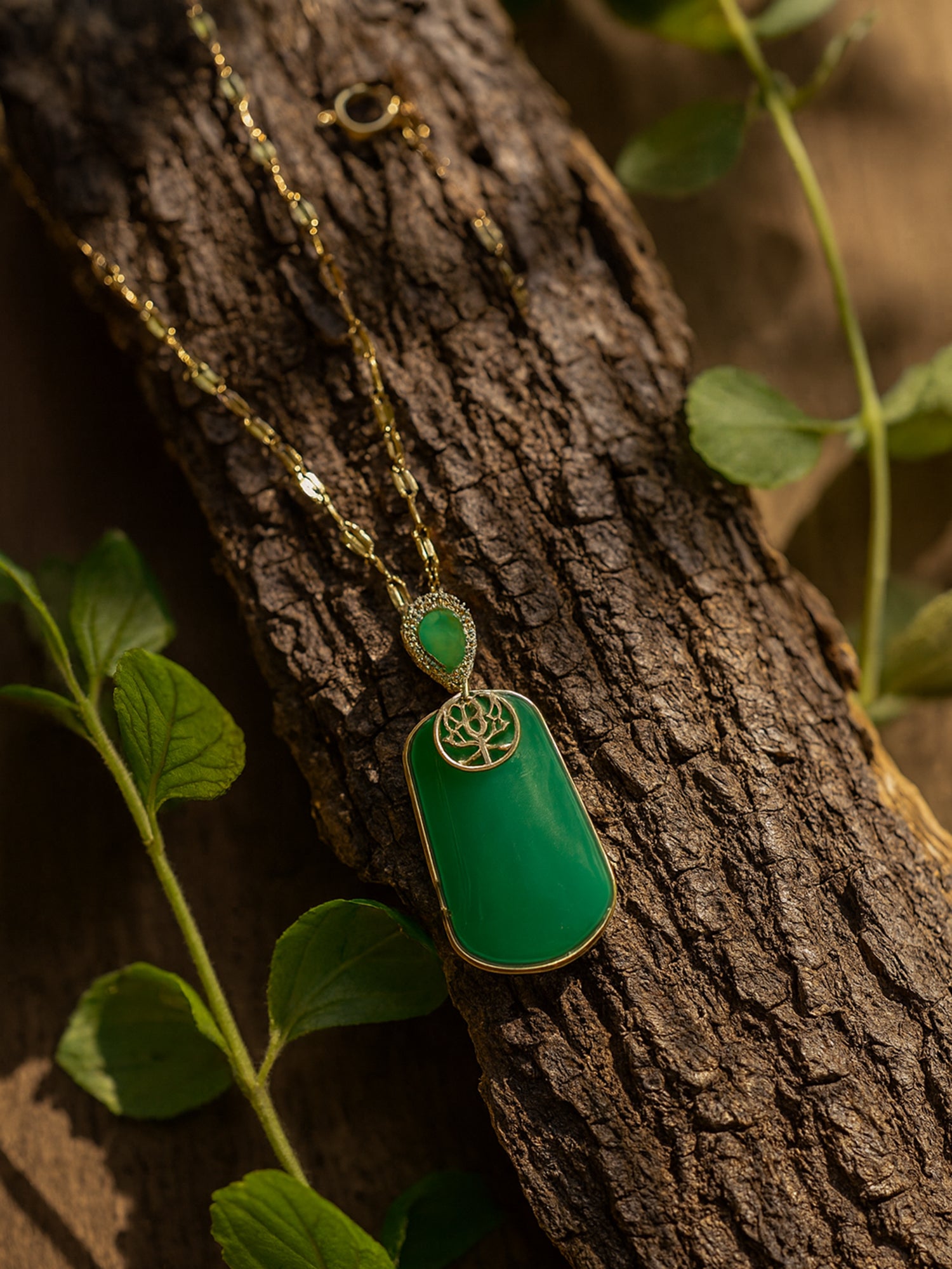 A high-end jewelry piece showcasing the latest gold necklace designs and a sparkling teardrop accent on a rustic wood background.