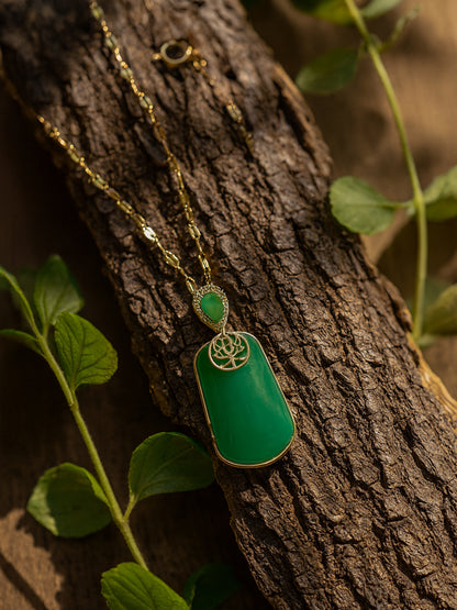 A high-end jewelry piece showcasing the latest gold necklace designs and a sparkling teardrop accent on a rustic wood background.