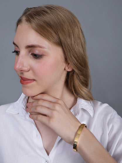 Side view of a model showcasing the latest bracelet design in gold with a side-clasp mechanism.