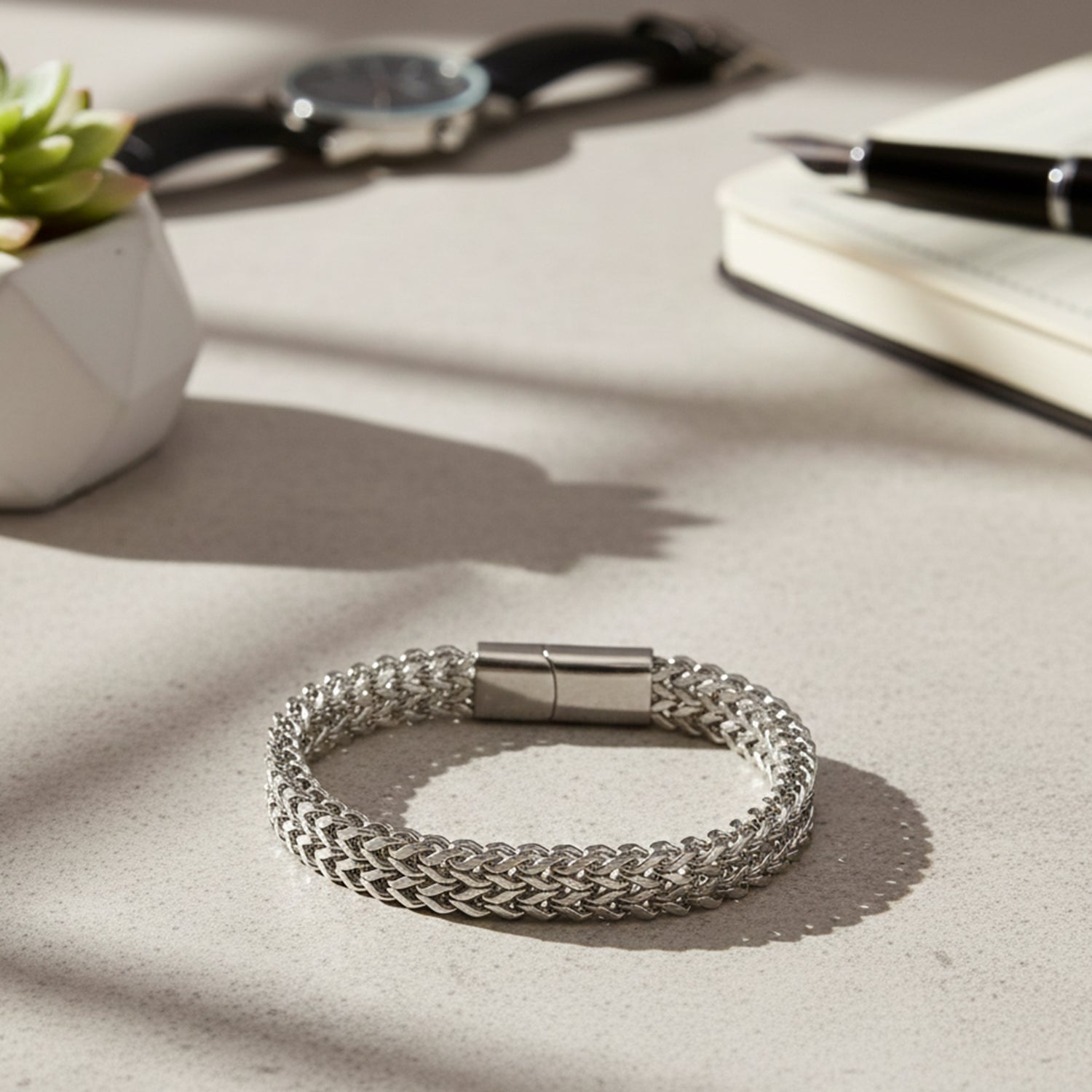 The latest bracelet design in silver featuring a secure magnetic clasp and intricate weave.