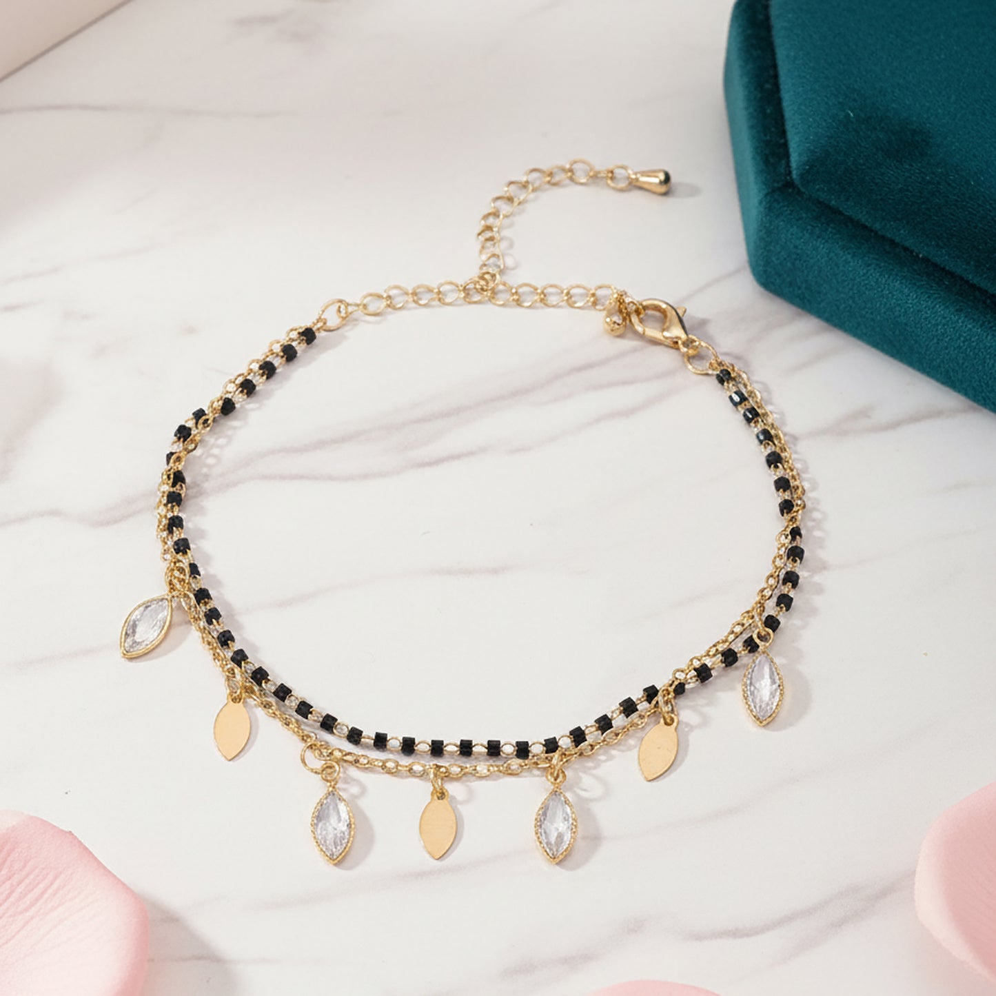 Women’s mangalsutra design with black beads and gold charms.